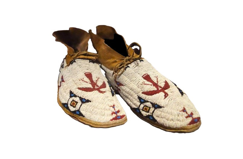 Pair of traditional beaded shoes on a white background