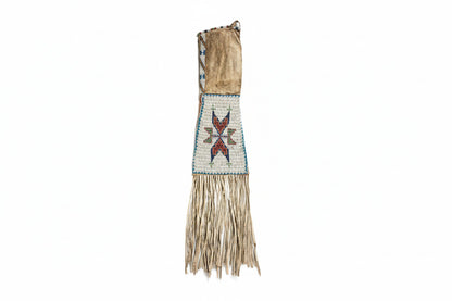 Traditional beaded and fringed garment on a white background