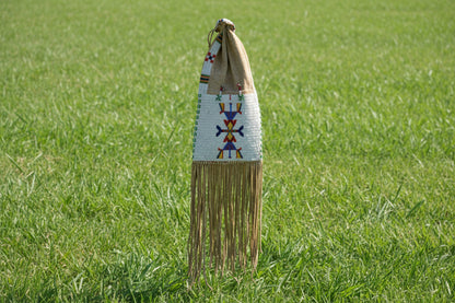 Decorative bag with fringe and colorful patterns on a white background
